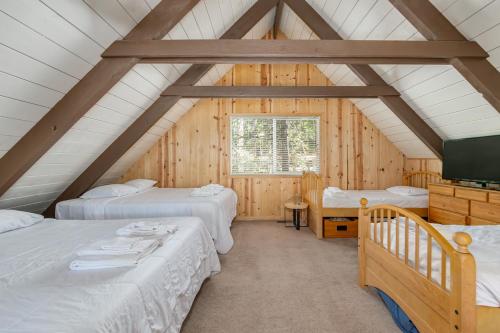 a room with three beds in a wooden cabin at Pops Place in Arnold