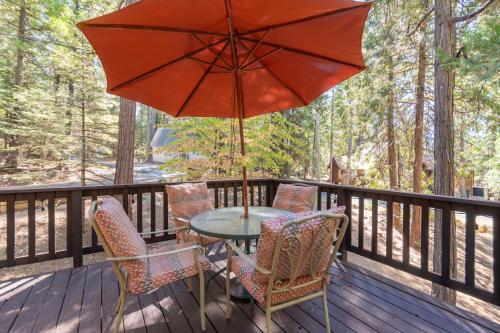 a table and chairs on a deck with an umbrella at Pops Place in Arnold