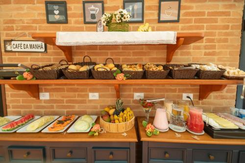a buffet with many different types of food on display at Pousada Santa Felicidade in Campos do Jordão