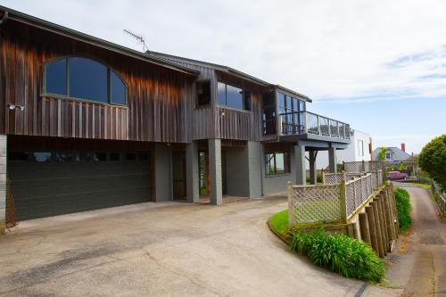 a house with a balcony on the side of it at Georges New Plymouth Central in New Plymouth