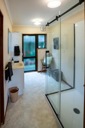a bathroom with a glass shower and a sink at Georges New Plymouth Central in New Plymouth