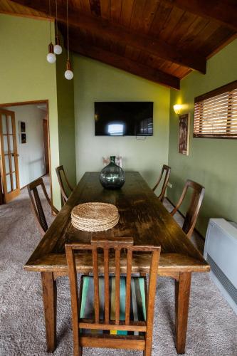 a dining room with a wooden table and chairs at Georges New Plymouth Central in New Plymouth
