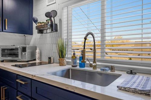 a kitchen counter with a sink and a window at Rucker Avenue Cozy Bungalow in Everett