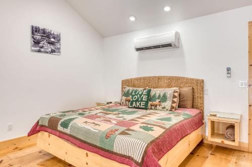 a bedroom with a bed with a quilt at Cottage Like Suite with Private Hot Tub in Bass Lake