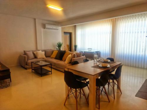 a living room with a table and a couch at Firstfloorby22 in Matosinhos
