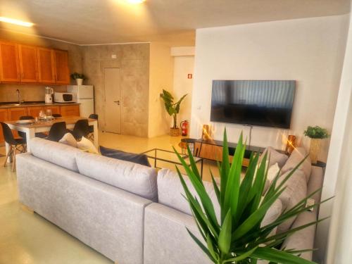 a living room with a couch and a television at Firstfloorby22 in Matosinhos