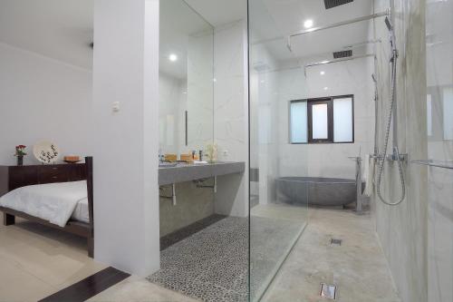 a bathroom with a shower and a sink and a tub at Kedis Bali Villa in Kuta