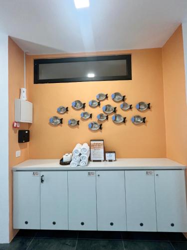 a room with a counter with fish plates on the wall at Roxy Sematan Beach Townhouse Deluxe 7 ,8 ,9, 10 ,11 ,12 in Sematan