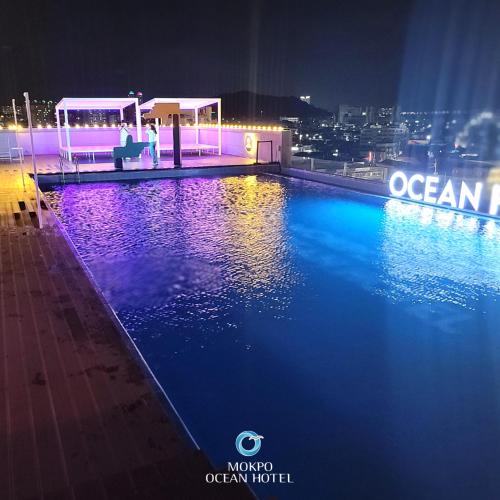 a swimming pool on top of a building at night at Mokpo Ocean Hotel in Mokpo