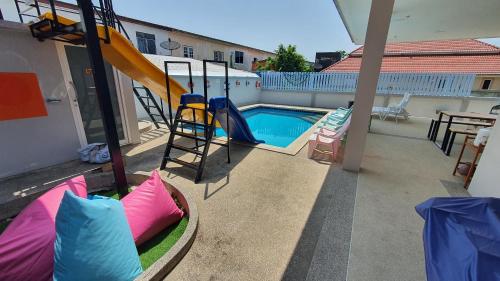 a playground with a slide and a swimming pool at Family Pool Villa Chaam in Cha Am