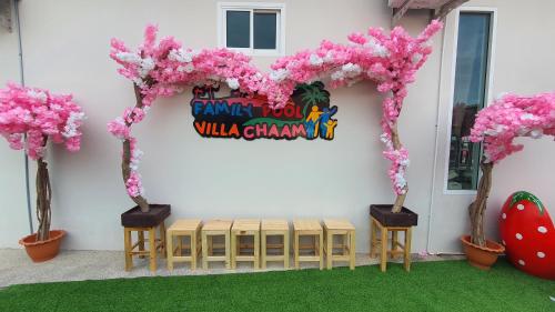 a table with a heart made out of pink flowers at Family Pool Villa Chaam in Cha Am