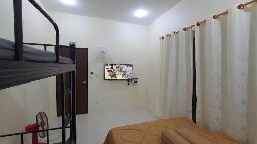 a bedroom with a bunk bed and a curtain at Family Pool Villa Chaam in Cha Am