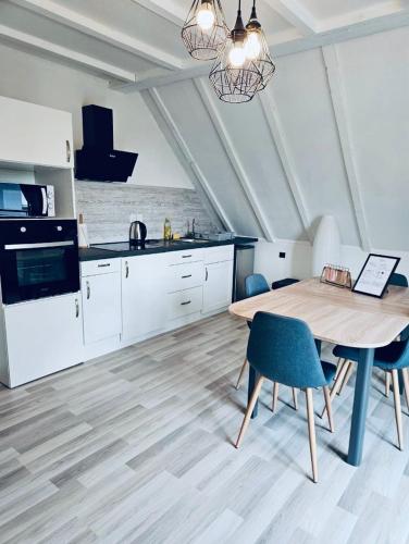 une cuisine avec une table en bois et une salle à manger dans l'établissement Spacieux - Parking Gratuit - Proche de Strasbourg, à Ostwald