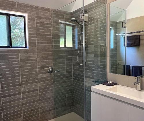 a bathroom with a shower and a sink at Edgewater Terraces at Metung in Metung