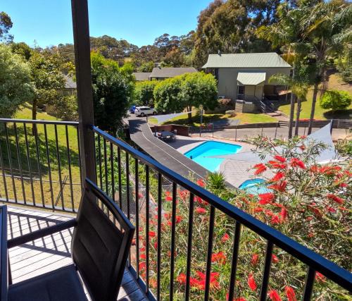 a balcony with a bench and a swimming pool at Edgewater Terraces at Metung in Metung