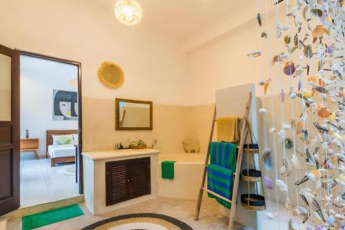 une salle de bain avec une baignoire, un lavabo et un miroir dans l'établissement Taman pangeran villa in Seminyak, 2BR large pool, Prime Location !, à Seminyak