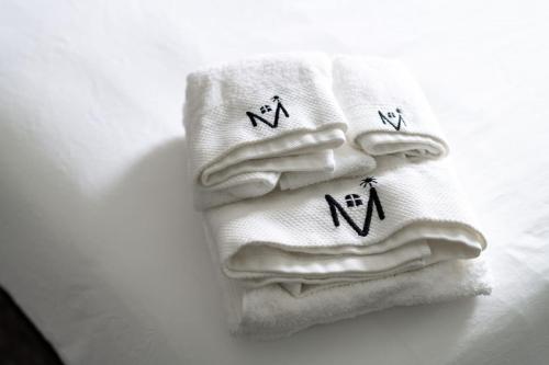 two white towels with crosses on them on a table at Cozy Home Plainfield Indy in Plainfield