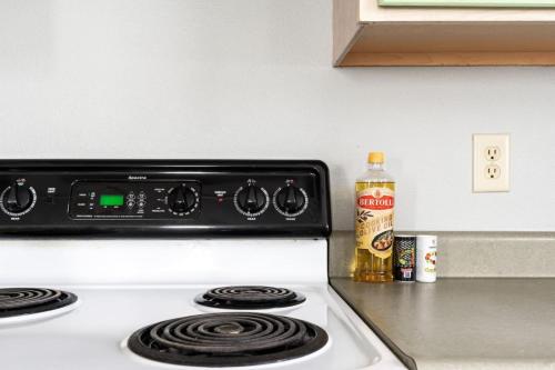 a stove top oven with a bottle of oil next to it at Cozy Home Plainfield Indy in Plainfield