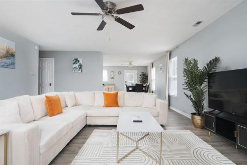 a white living room with a white couch and a tv at Cozy Home Plainfield Indy in Plainfield