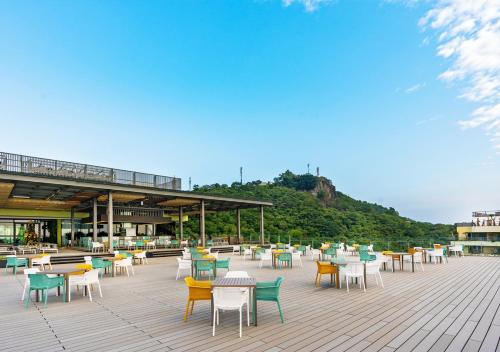 a group of tables and chairs on a patio at Flamingo Resort Cat Ba in Cat Ba
