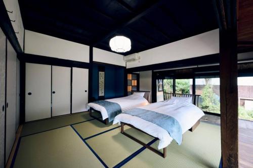 OMOYA総領 時を紡ぐ茅葺きの宿 - Thatched inn that spins time - Supported by COCOSTAYにあるベッド