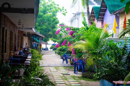 an empty street with tables and chairs and plants at Chef Panyang Beach Resort Okoy in Ocoy