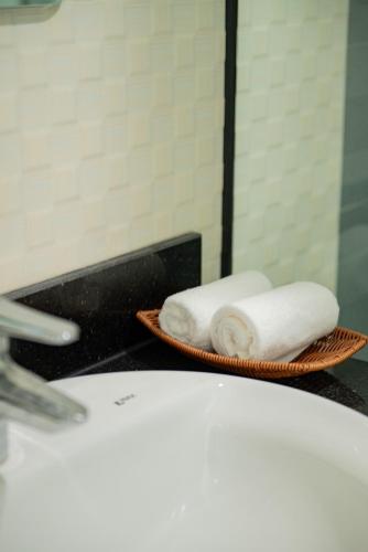 two baskets of towels on a counter in a bathroom at Garden Hotel II in Ha Giang