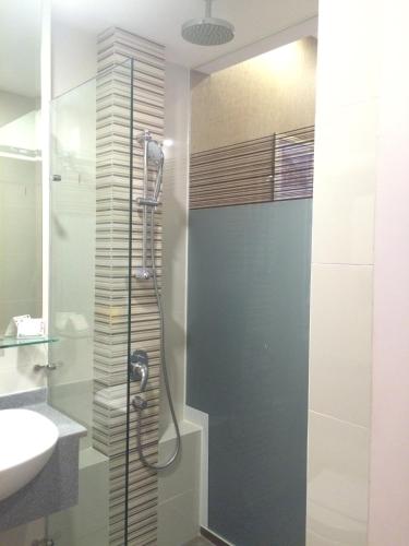 a bathroom with a shower and a sink at Hotel Grand Central in Singapore