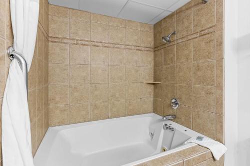 a bath tub in a bathroom with a shower at Best Western Gaylord in Gaylord