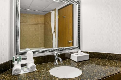 a bathroom with a sink and a large mirror at Best Western Gaylord in Gaylord