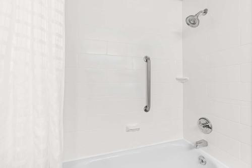 a white bathroom with a tub and a shower at Best Western Gaylord in Gaylord