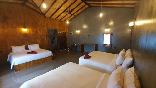 a bedroom with two beds in a room at Ceylon Resort Wilpattu in Wilpattu