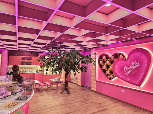 a pink room with a heart on the wall at Flamingo Resort Dai Lai in Ngọc Quang