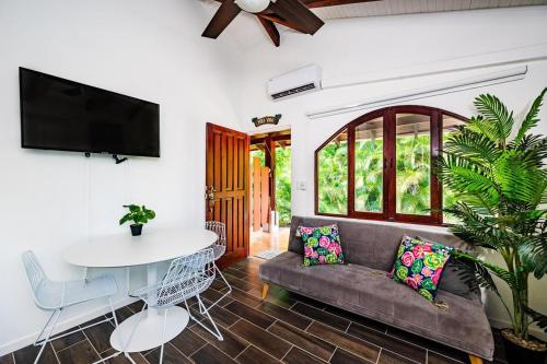 a living room with a couch and a table at Couples Tropical Getaway with Pool, Playa Potrero in Potrero