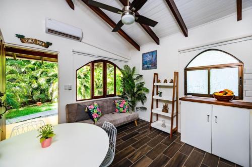 a living room with a table and a couch at Couples Tropical Getaway with Pool, Playa Potrero in Potrero