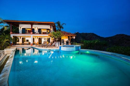 a swimming pool in front of a house at Spectacular Ocean Views Infinity Pool in Potrero