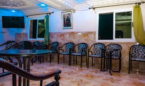a room with a bunch of chairs and tables at Hotel Ain Leuh in Aïn Leuh