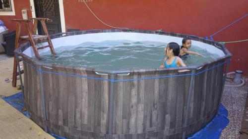 two children in a jacuzzi in a barrel of water at Hotel Ain Leuh in Aïn Leuh
