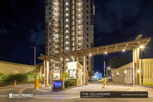 a tall building with lights in front of a building at The Celandine Balintawak Quezon City in Manila