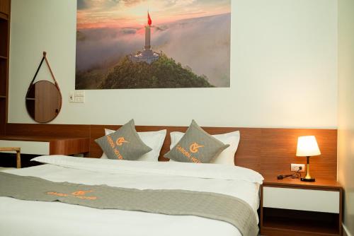 a hotel room with a bed and a tower at Garden Hotel II in Ha Giang