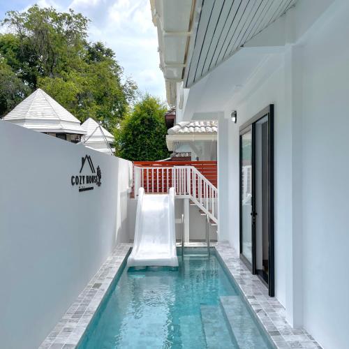 a pool with a slide in a house at 3 Bedroom Pool Villa, Cozy House, Wonnapha Beach, Bangsaen in Ban Bang Saen (1)