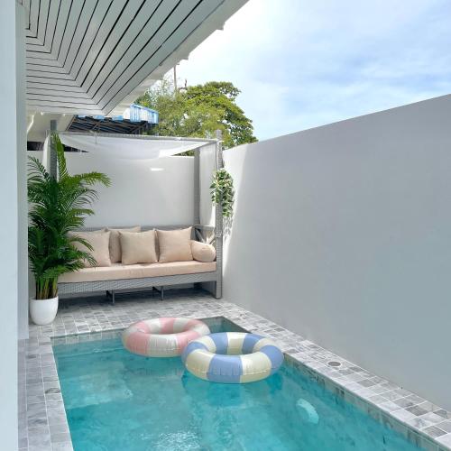 a swimming pool with two inflatables in a house at 3 Bedroom Pool Villa, Cozy House, Wonnapha Beach, Bangsaen in Ban Bang Saen (1)