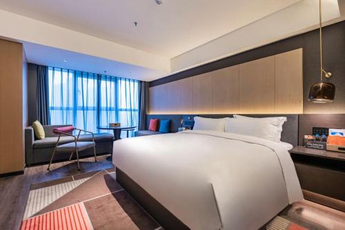 Ein Bett oder Betten in einem Zimmer der Unterkunft Mehood Lestie, Qujiang Dayan Pagoda Datang Everlasting City Jinhui Plaza