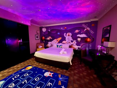 a purple bedroom with a bed with a purple ceiling at Merchant Hotel in George Town