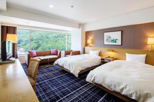 Postel nebo postele na pokoji v ubytování Kofu Kinenbi Hotel