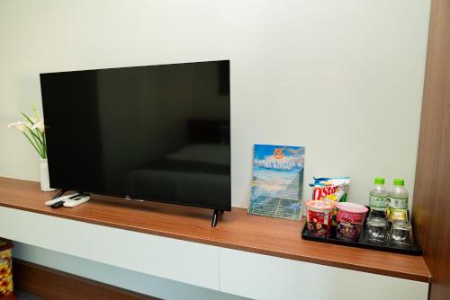 a flat screen tv sitting on a wooden shelf at Garden Hotel II in Ha Giang