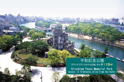 a building in a park next to a river at Grand Prince Hotel Hiroshima in Hiroshima