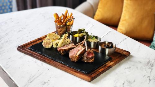 a tray of meat and vegetables on a table at Imperial Lexis Kuala Lumpur in Kuala Lumpur