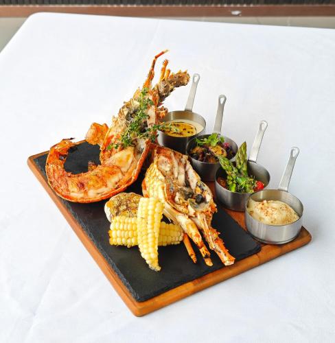 a tray of seafood and corn on a table at Imperial Lexis Kuala Lumpur in Kuala Lumpur