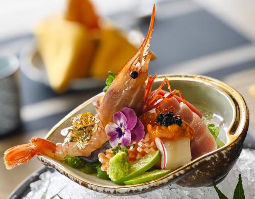 a plate of food with seafood on a table at Imperial Lexis Kuala Lumpur in Kuala Lumpur